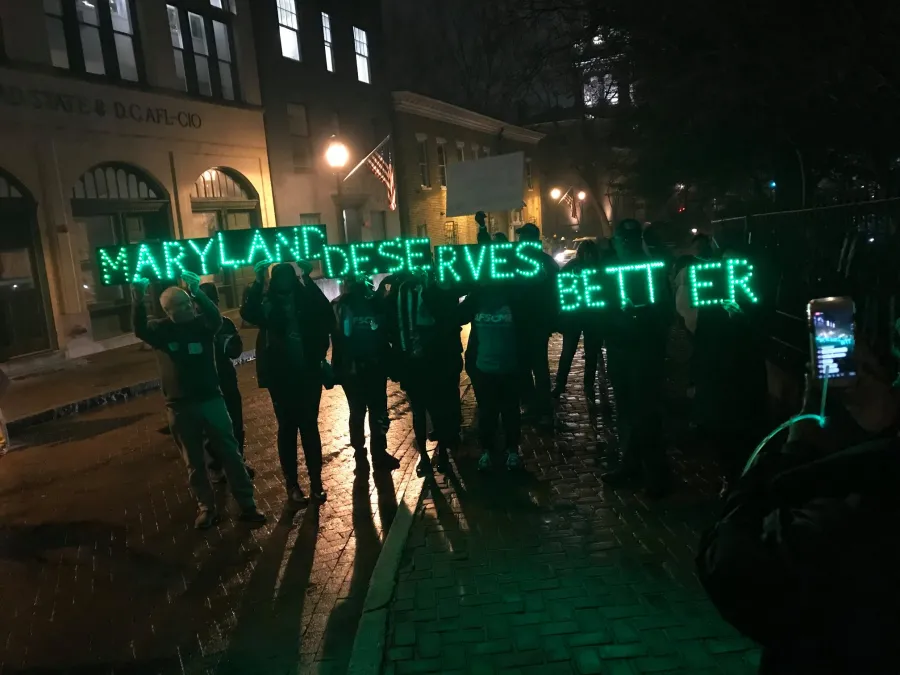 AFSCME members hold up a Maryland Deserves Better sign