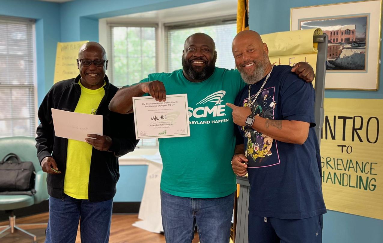 AFSCME Local 2898 Member Mike Hill standing with Local 631 member Kenny Nugent and Local President Wynton Johnson