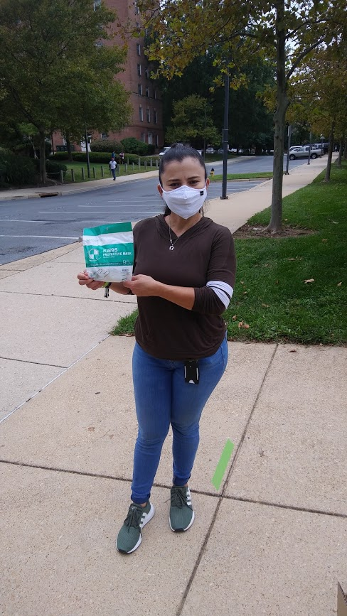 AFSCME member Maria Ayala holds up masks